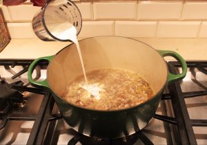 heavy cream pouring into pot