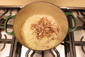 chopped onions and mushrooms in pot on stove