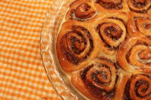 iced cinnamon rolls on dish