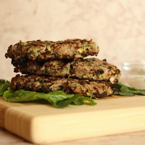 stacked turkey burgers on wooden board
