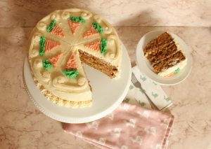 carrot cake on cake stand sliced